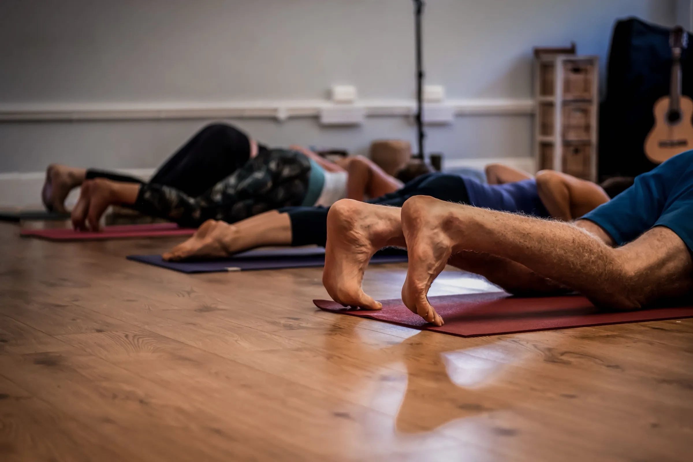 Students lying on their mats at the end of a class