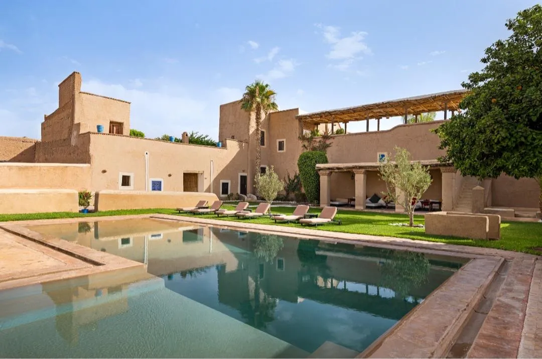 The pool and terracotta buildings of Tigmi hotel, Morocco