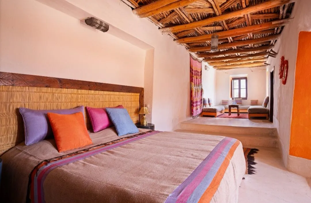 A bedroom with a beamed ceiling at Tigmi, Morocco