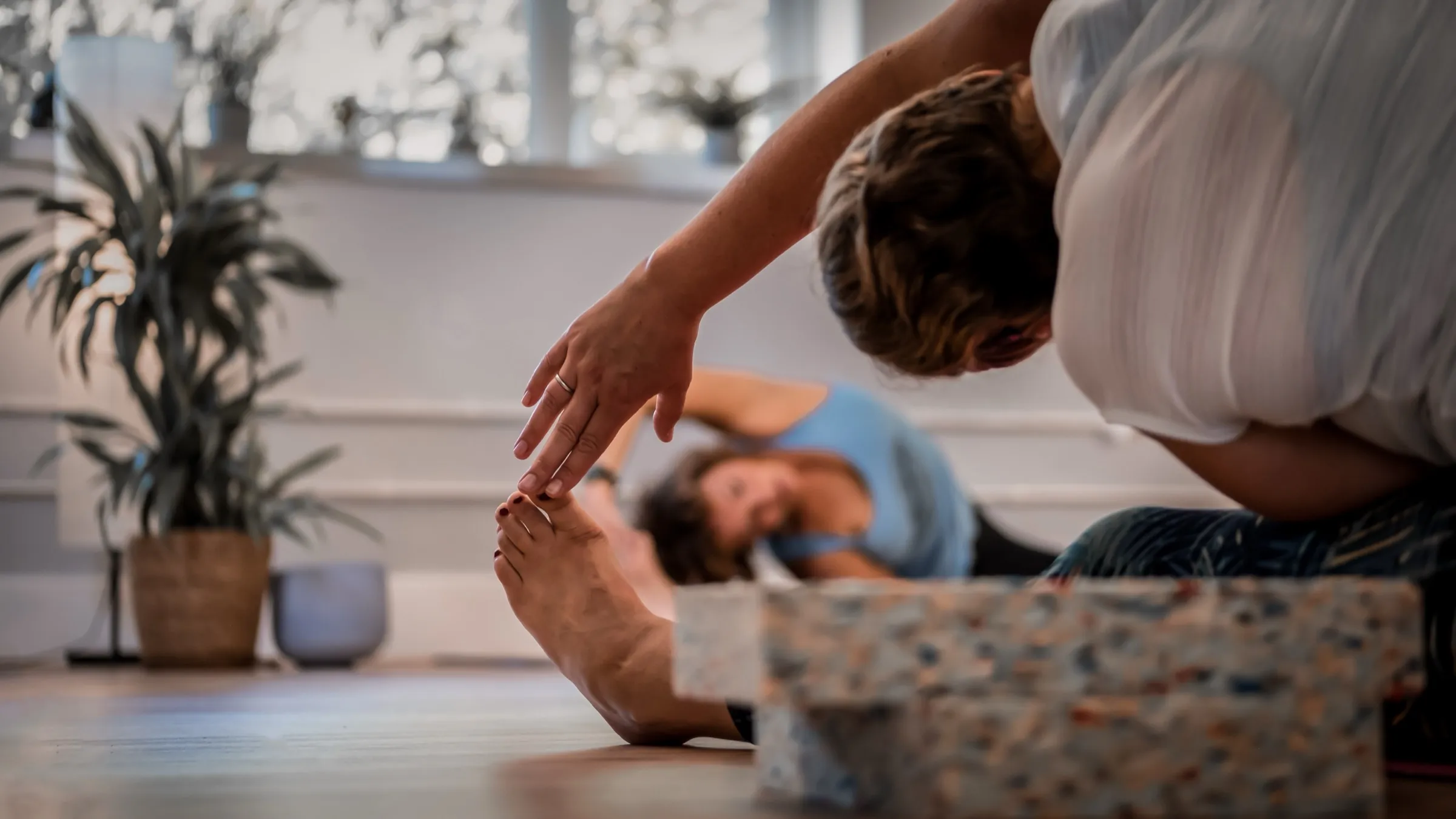 Mirella adjusting a student’s stretch