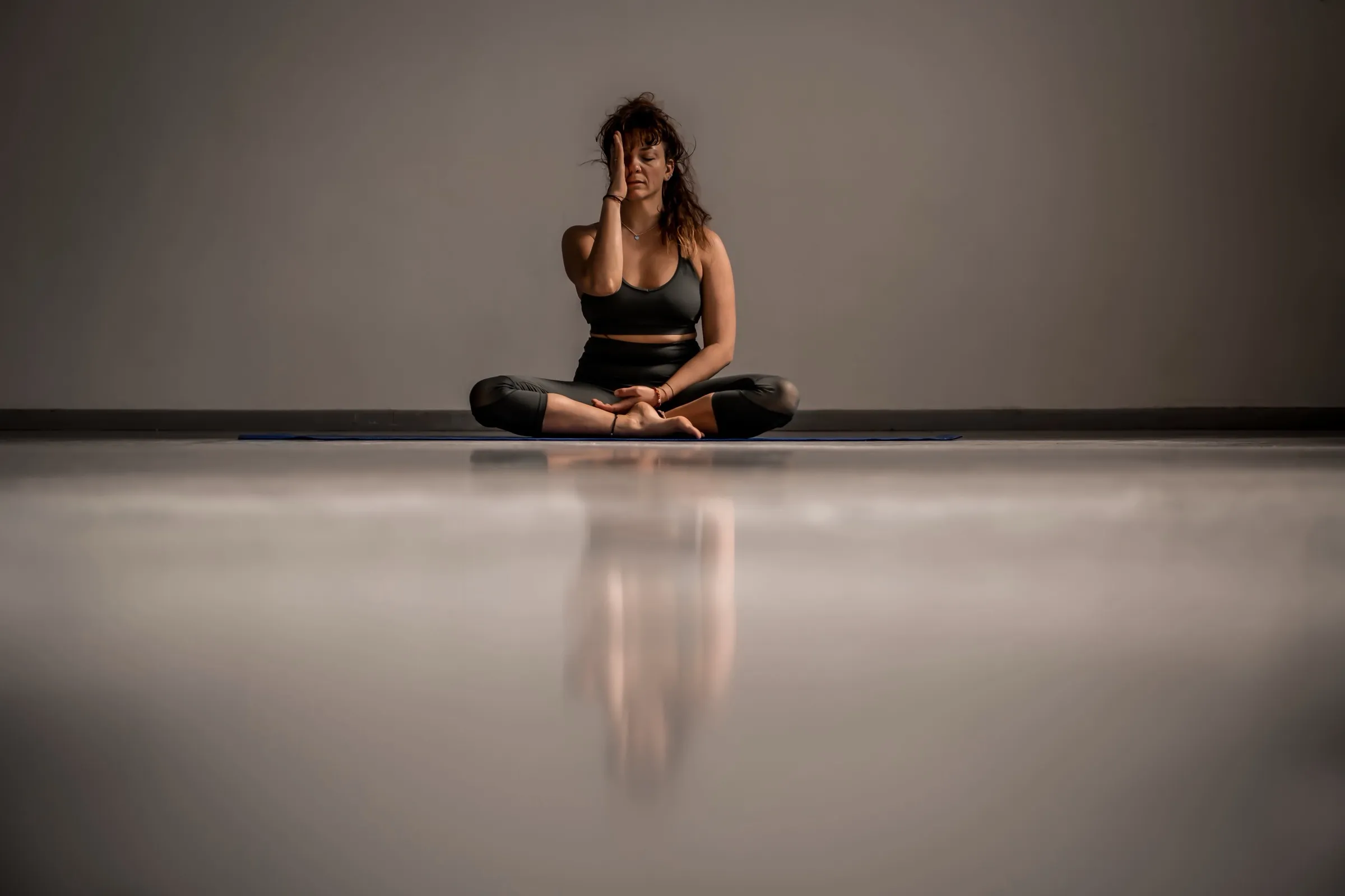 Mirella meditating in a yoga studio